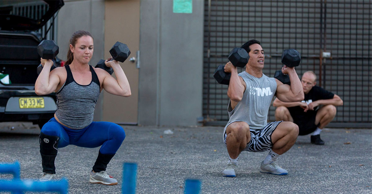 athletes doing dumbbell squats