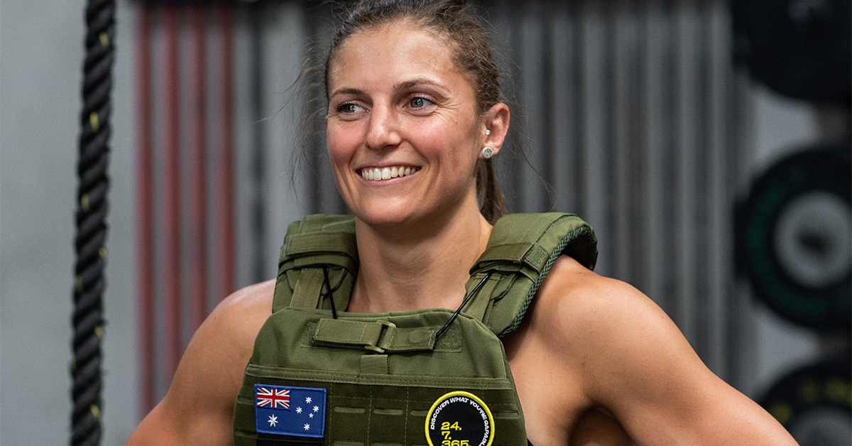 smiling woman running with a weighted vest