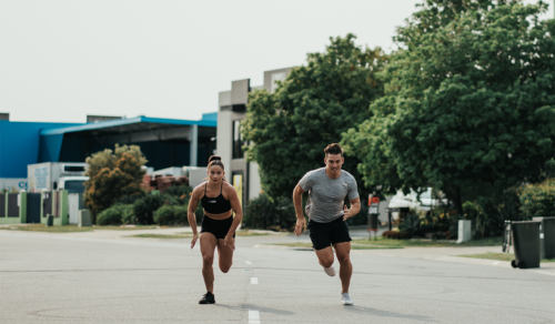 two athletes running wearing training shoes for functional fitness