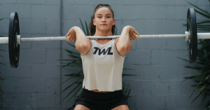 female athlete performing power clean