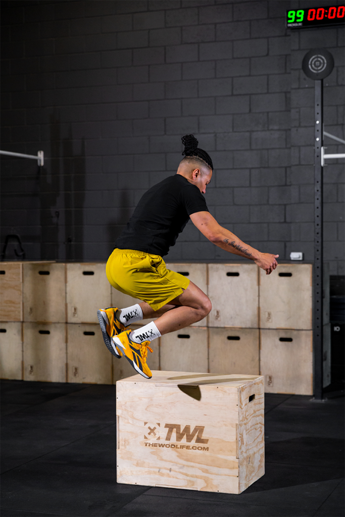 athlete doing box jump sets and reps in gym