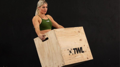 female athlete carrying TWL plyo box