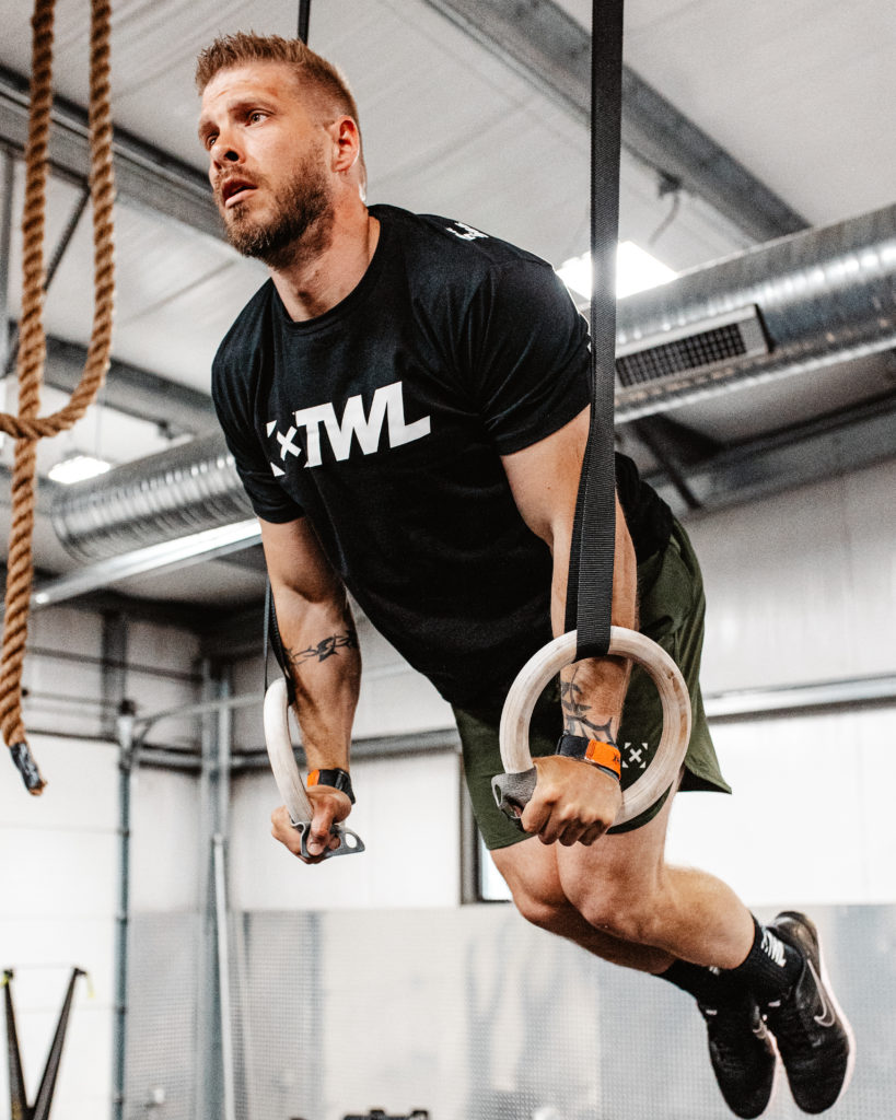 Male athlete performing muscle-ups
