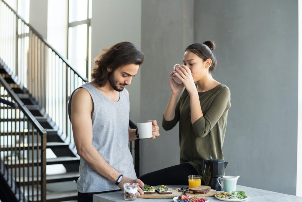 man and woman eating breakfast