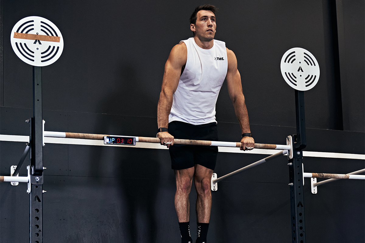 male athlete practicing bar muscle-ups